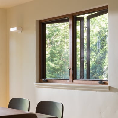 Dining room with open casement window letting in fresh air